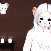 a white doll with black eyes and the word voo on the front