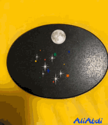 a black oval with a full moon surrounded by stars and the name ali abdi on the bottom
