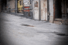 a blurred image of a street with a few buildings and a sign that says ' a ' on it