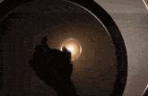 a reflection of a person in a mirror with a light coming through it