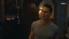 a man in a superhero costume is looking at another man