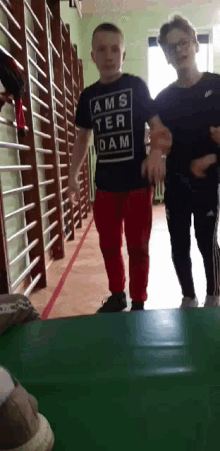 a boy wearing a shirt that says ams ter dam on it