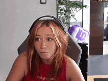 a woman wearing headphones and a red shirt that says " i do n't know " on it