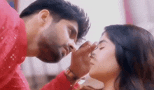 a man is applying makeup to a woman 's nose .