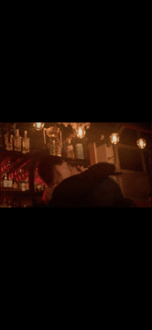 a blurry picture of a bar with bottles of alcohol