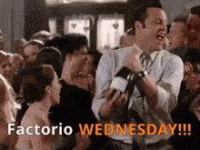 a man in a suit and tie is dancing in a crowd with the words factorio wednesday !!!