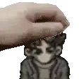 a pixel art of a hand putting a person 's head on a table .