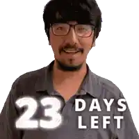 a man wearing glasses and a shirt that says 23 days left is smiling