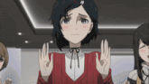 a girl in a red sweater is making an ok sign with her hands