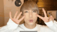 a man making a peace sign with his hands