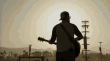 playing guitar jordan davis stagecoach sunset silhouette