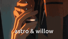 a close up of a person 's hand with the words astro & willow written above it