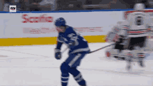 a hockey game is being played in front of a sn banner