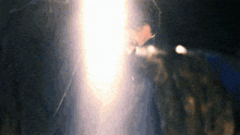 a close up of a person 's face with a light coming from it