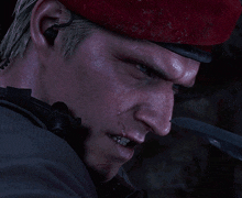a close up of a man 's face wearing a red beret