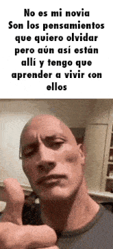 a bald man is giving a thumbs up in a room .