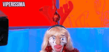 a woman in a christmas costume is standing in front of a camera with the words viperissima on the bottom .