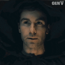 a close up of a man 's face with genv written on the bottom right