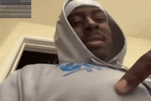 a man wearing a hoodie and a shirt that says r on it