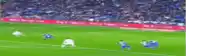 a blurry picture of a soccer game with a crowd in the stands .