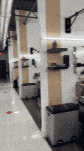 a blurred image of a hallway with a trash can on the right