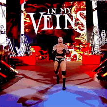 a wrestler is running down a ramp with the words in my veins behind him