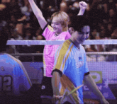 a man wearing a shirt that says sky is holding a tennis racket