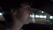 a man in a car with a piece of paper on his mouth