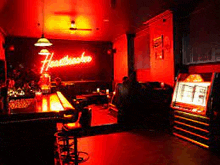a bar with a neon sign that says heartbeat on it