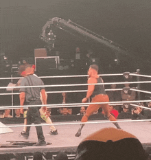 a man in a wrestling ring with a w logo on the ring