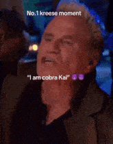 a close up of a man 's face with the words " i am cobra kai " on it