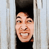 a man making a funny face behind a fence