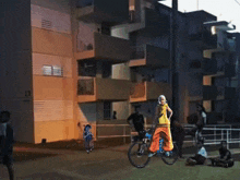 a man is doing a trick on a bike in front of a building that has the number 13 on it