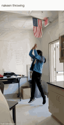a man is jumping in the air in front of an american flag