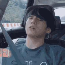 a man is sleeping in the back seat of a car with his eyes closed