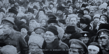 a black and white photo of a crowd of people with the words and the heart is uneasy in the chest