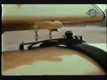 a blurred image of a person standing on a table with a clock in the background