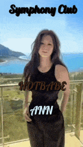 a woman standing on a balcony with the words symphony club hotbabe ann written above her