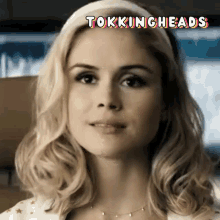 a close up of a woman 's face with the words tokingheads above her head