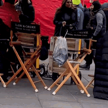 two wooden director 's chairs that say law & order