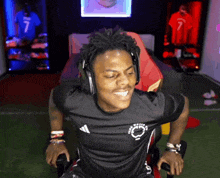a man wearing headphones and a black shirt that says club world on it