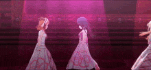 a group of anime girls are standing on a stage in front of a pink background .