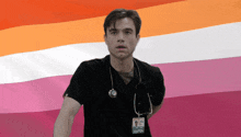 a man with a stethoscope around his neck has a badge that says doctor