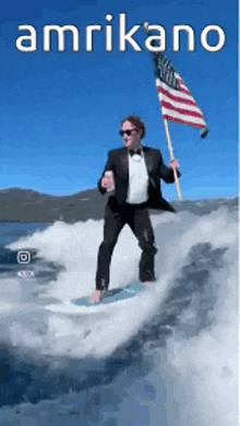 a man in a tuxedo is riding a wave on a surfboard holding an american flag