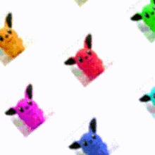 a bunch of colorful stuffed animals on a white surface