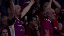 a man wearing a scarf that says lleida is cheering in the stands