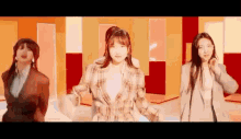 a group of women are dancing together in a room in a video .