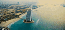 an aerial view of a large building floating in the middle of the ocean .