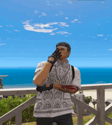 a man standing on a balcony looking out over the ocean
