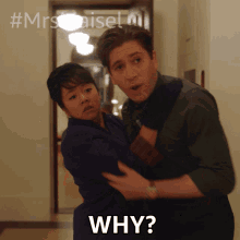 a man is holding a woman in his arms and says why